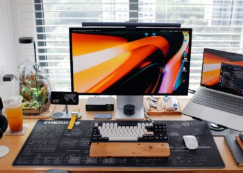 A sleek, modern desk setup with multiple screens.