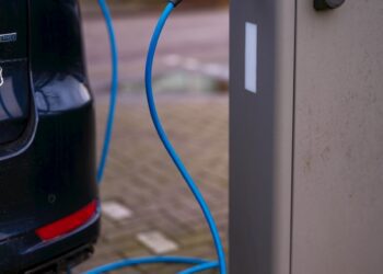 An electric car plugged in to a charging station