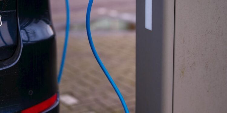 An electric car plugged in to a charging station