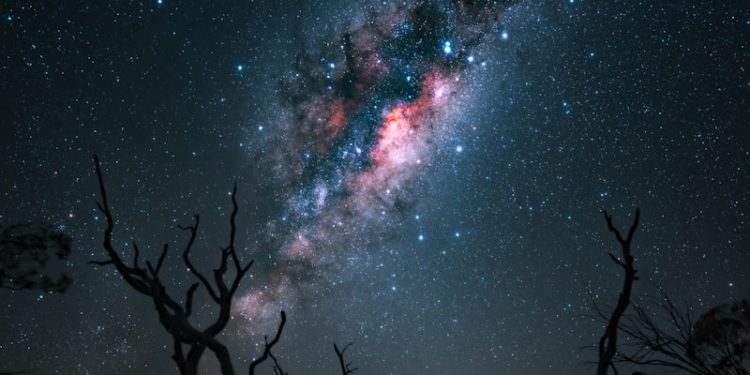 The milky way stretches across the night sky.