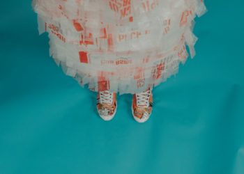 person wearing brown-and-white lace-up shoes