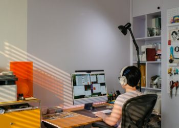 A person attends a virtual meeting on a computer.