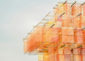 Abstract building with orange and pink hues.