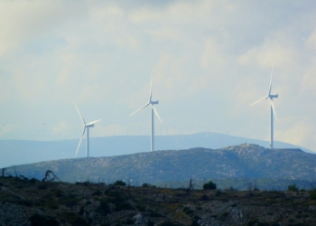 white wind turbines on green grass field during daytime