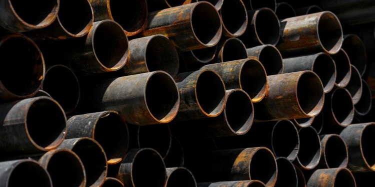 A large stack of pipes stacked on top of each other