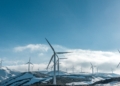 wind turbines on snowy mountain under clear blue sky during daytime