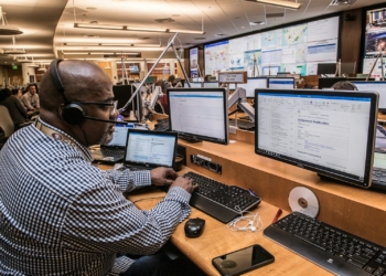 man in black and white checkered dress shirt using computer