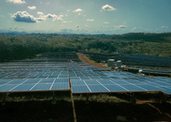 a large solar farm with many rows of solar panels