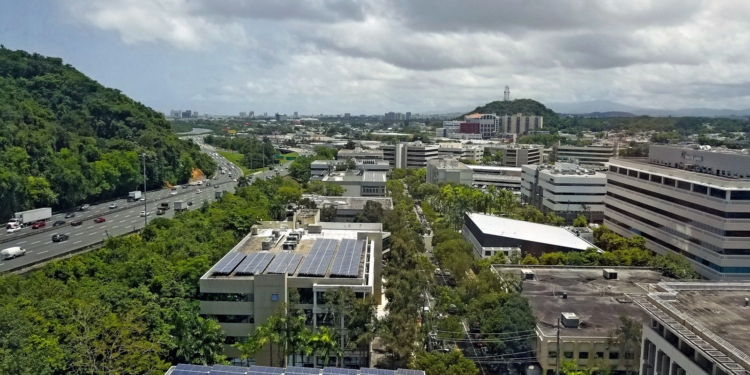 an aerial view of a city with solar panels