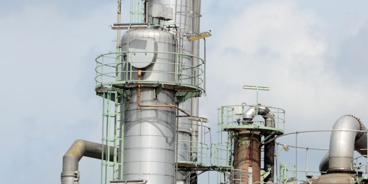 white and brown factory under blue sky during daytime