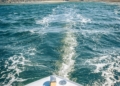 a view of the back of a boat in the water