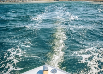 a view of the back of a boat in the water