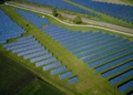 aerial photography of grass field with blue solar panels