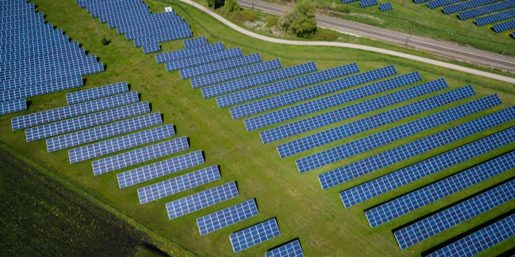 aerial photography of grass field with blue solar panels