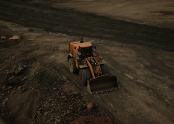a bulldozer on a dirt road in the middle of nowhere