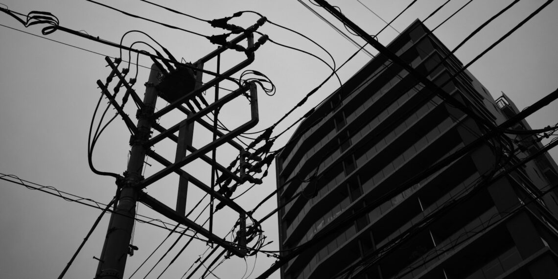 a tall building with power lines