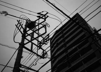 a tall building with power lines