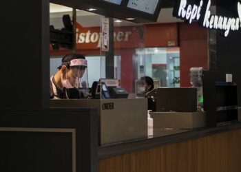 woman in black shirt sitting on chair
