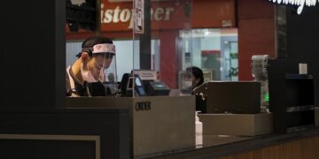 woman in black shirt sitting on chair