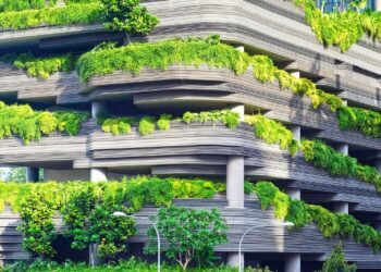 Green building with trees on balconies